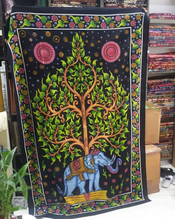 A large throw depicting an elephant with a tree of life growing from it's back.