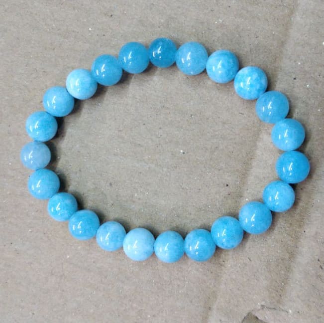 A beaded bracelet of blue pea sized aquamarine gemstone beads.