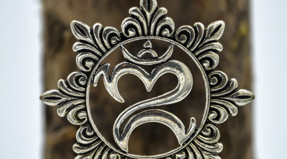 The new spiritual jewellery coming includes this Silver metal om symbol pendant with engraved flower petals around it.