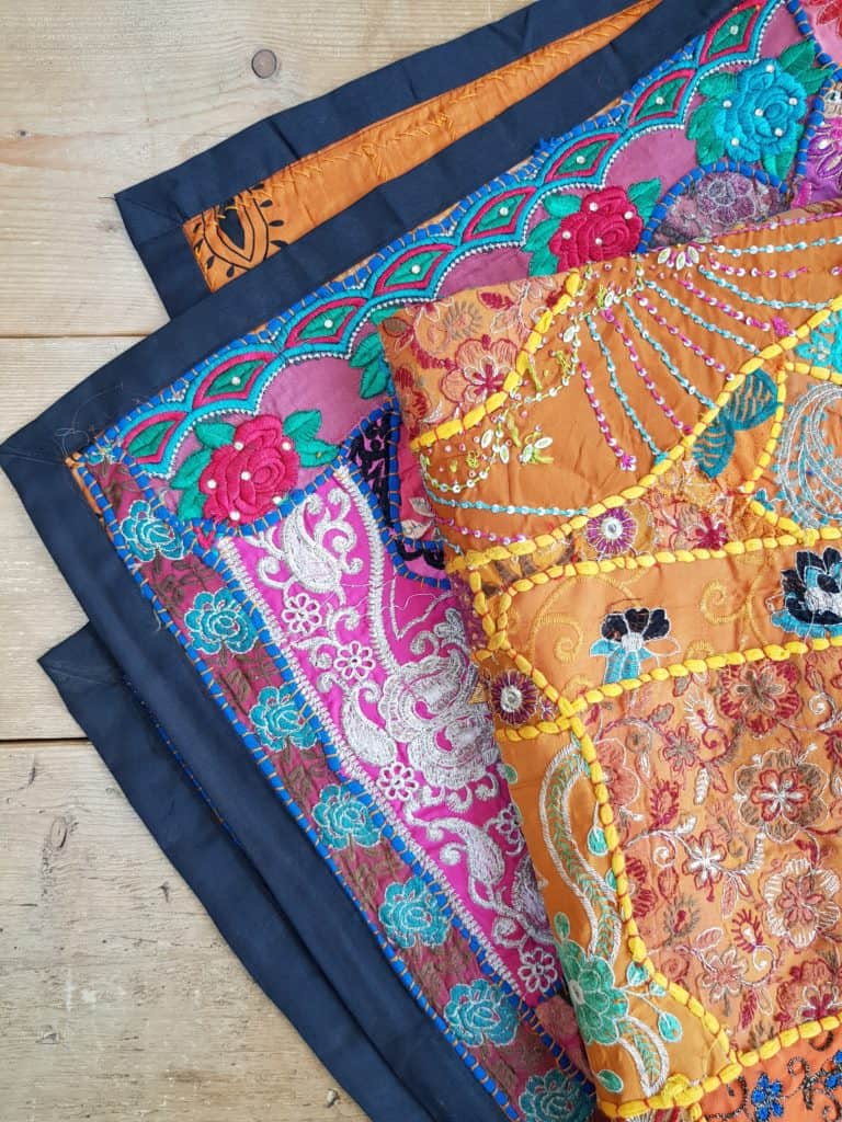These handmade indian tapestries are made from unique recycled embroidery patches and make unique gifts. Shown in an orange and turquoise version.