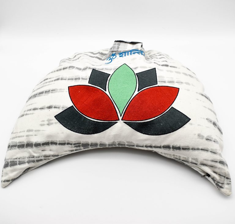 A crescent moon shaped lotus meditation cushion. The lotus is red green and dark grey. The fabric is a white and grey striped tie dye. Om shanti is embroidered in blue at the top.