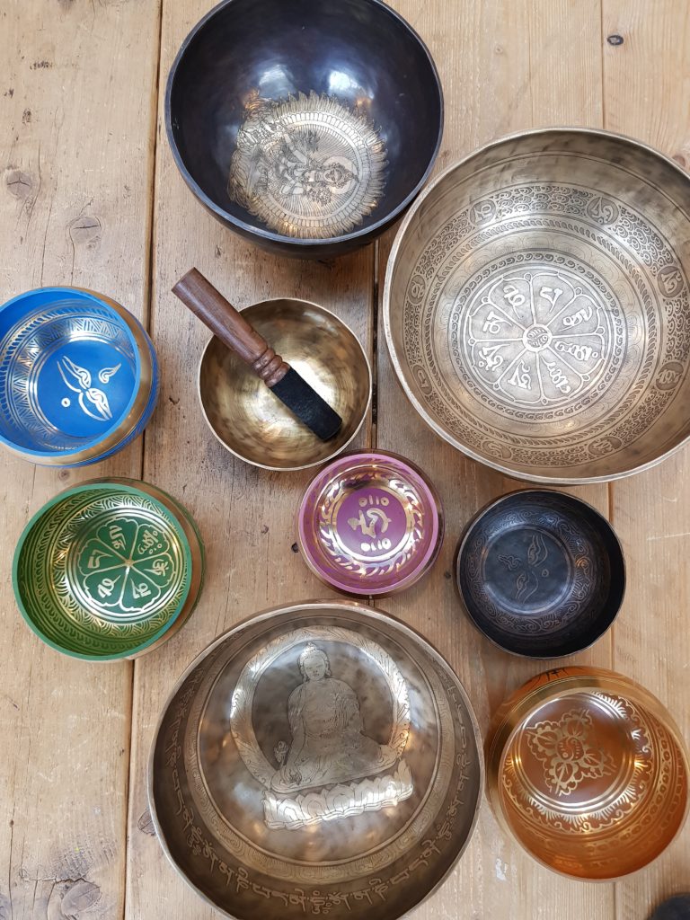 A selection of different singing bowls used as meditation aids. they are all different colours, sizes and textures arranged together