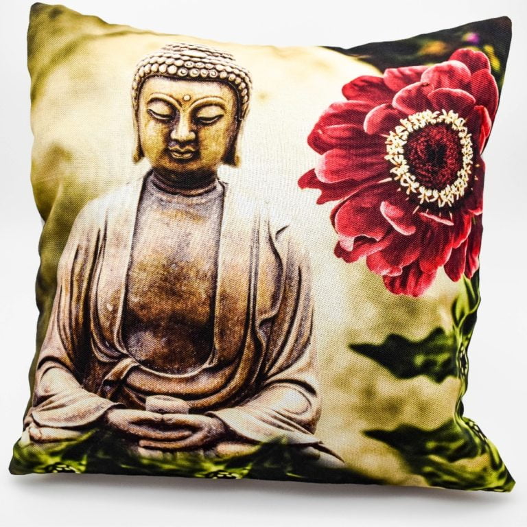 A buddha cushion cover with a printed buddha statue next to a large dark pink flower surrounded by green leaves