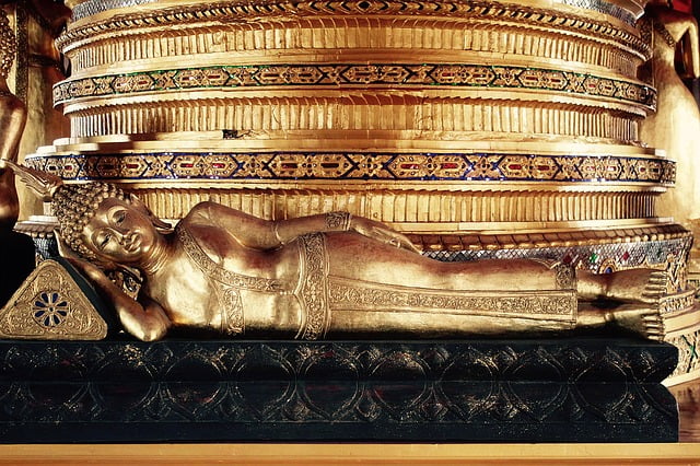 your birthday buddha for tuesday. a golden buddha laying down on his side