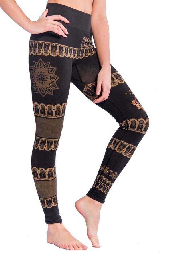 Bhakti high waist yoga leggings made from organic cotton blend. A model wearing the leggings showing the side view of the indian style motifs and a large mandala on the thigh