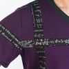 mens burgundy yoga t-shirt close up of mantra patchwork on the shoulder